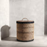 Hand‑woven rattan waste paper basket with fitted lid and dark olive detailing | Anboise