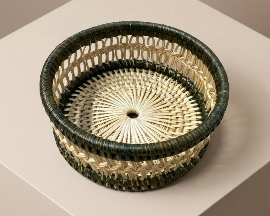 Round woven wine coaster with a dark green outer rim and a natural rattan inner weave | Anboise