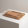 Set of three natural rattan trays stacked together - Anboise