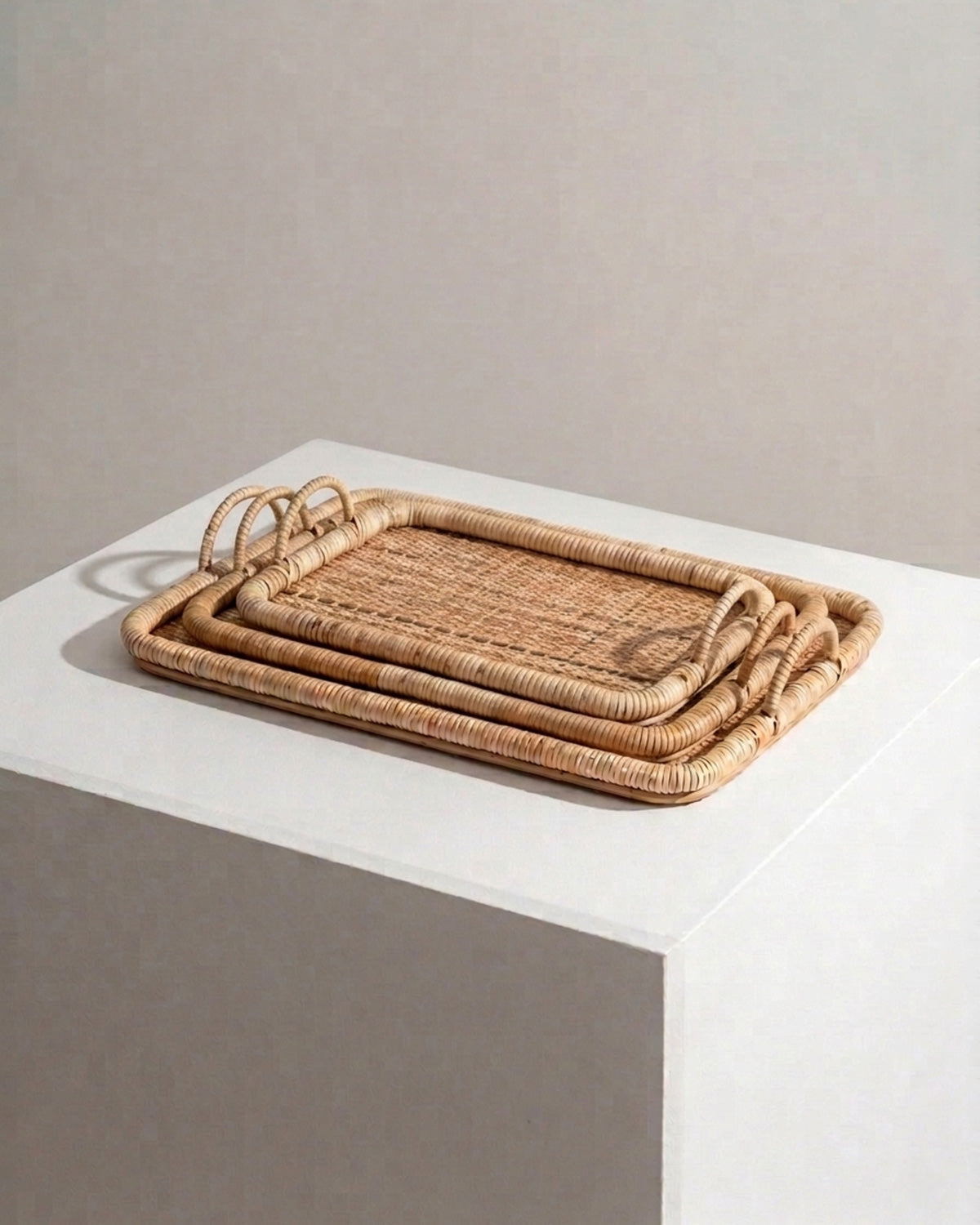 Set of three natural rattan trays stacked together - Anboise