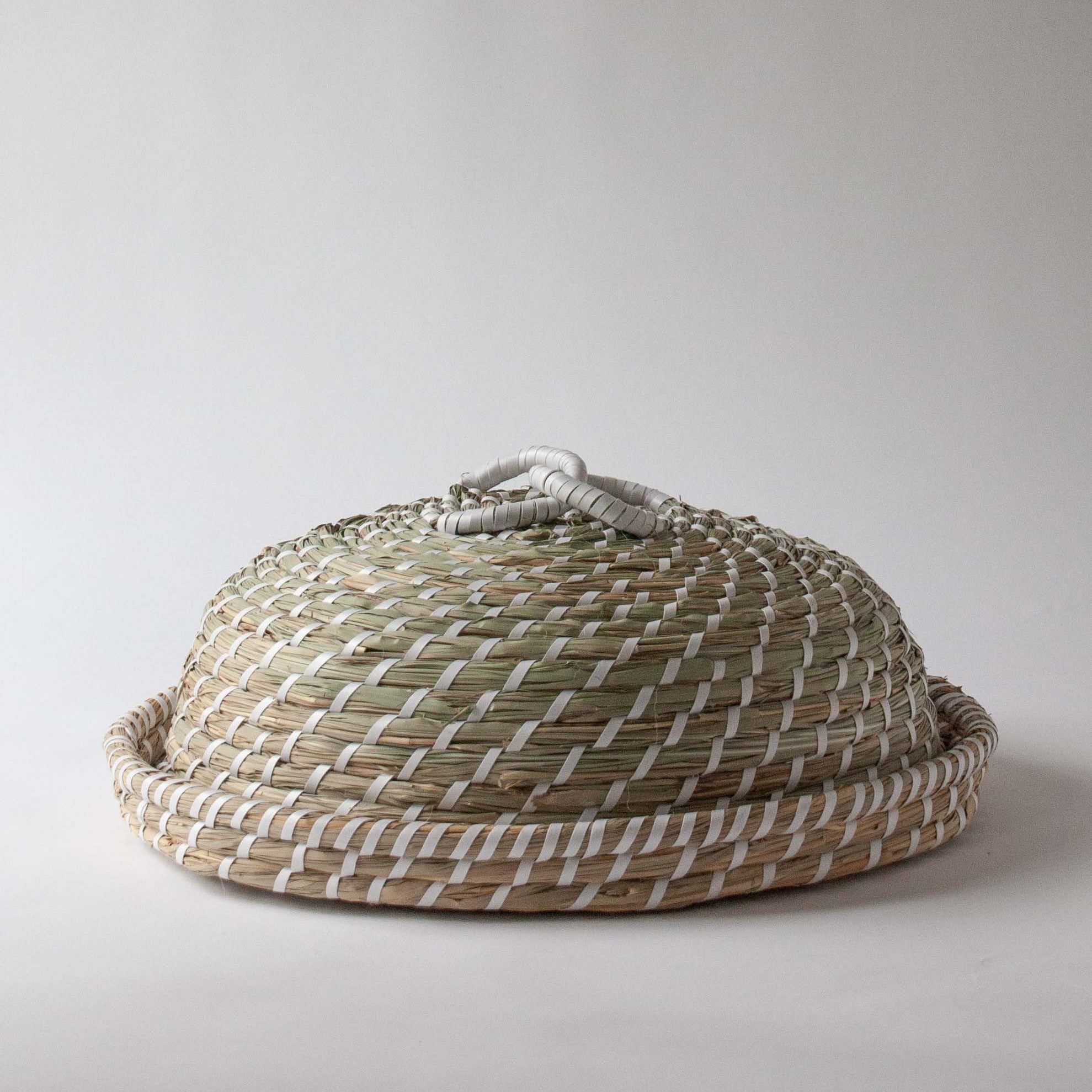 Hand woven from seagrass this luxury food cover cloche dome | Anboise