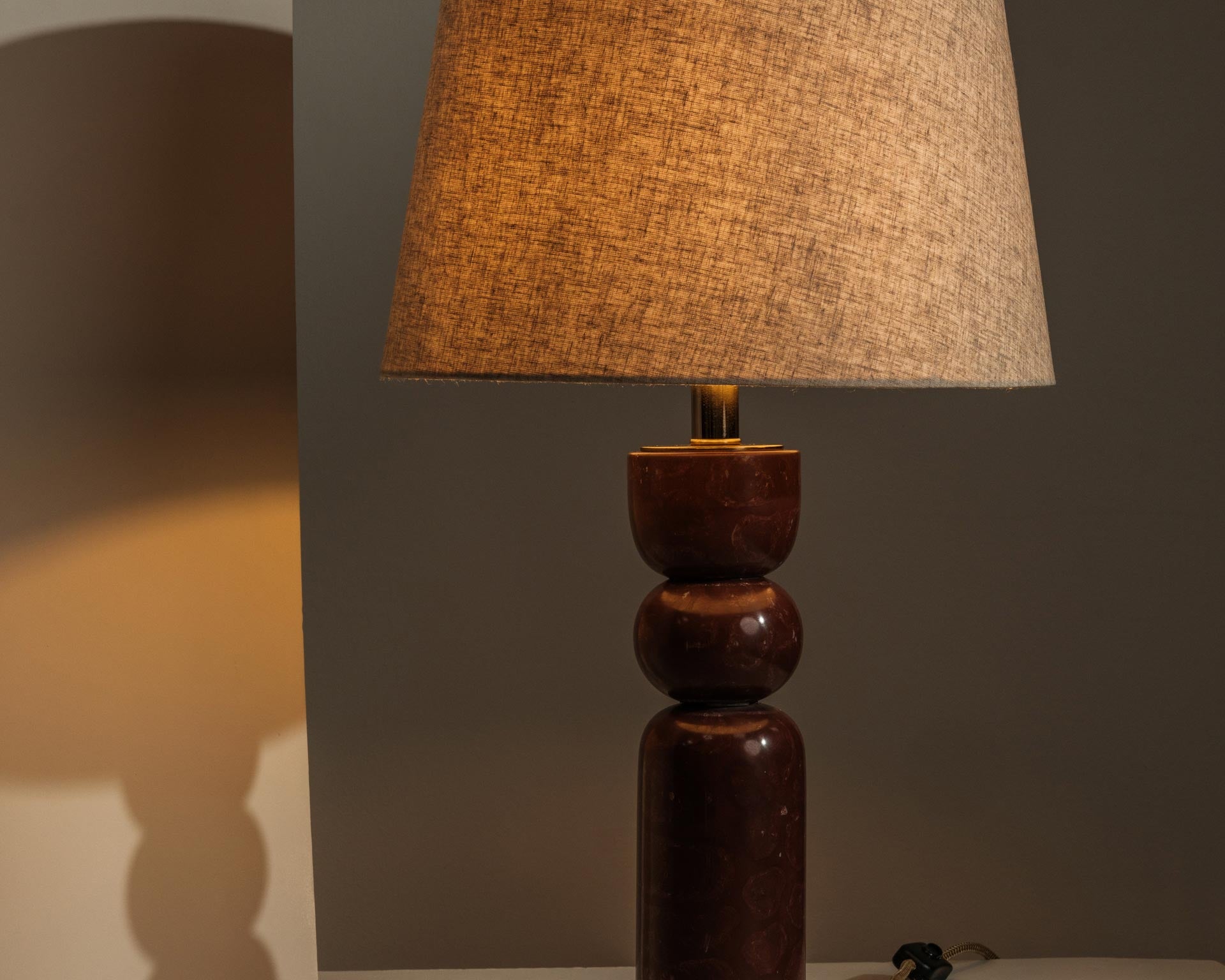 Marble table lamp casting warm, atmospheric light - Anboise