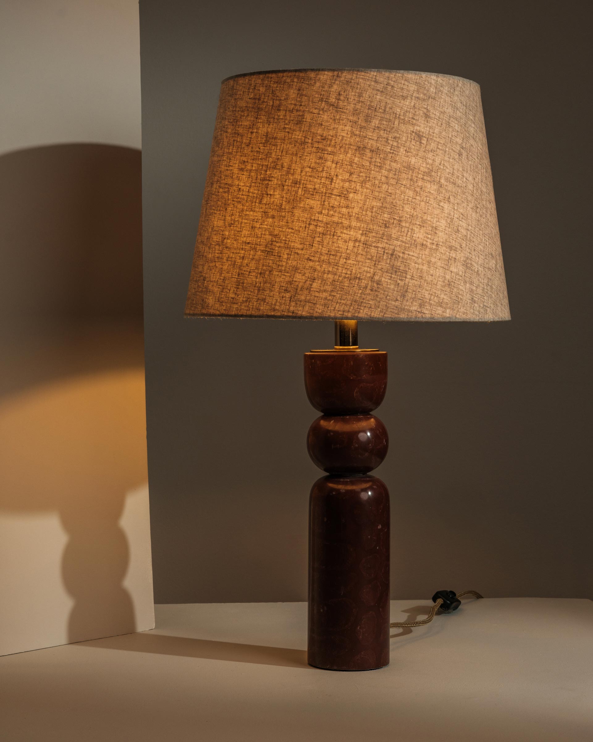 Marble table lamp casting warm, atmospheric light - Anboise