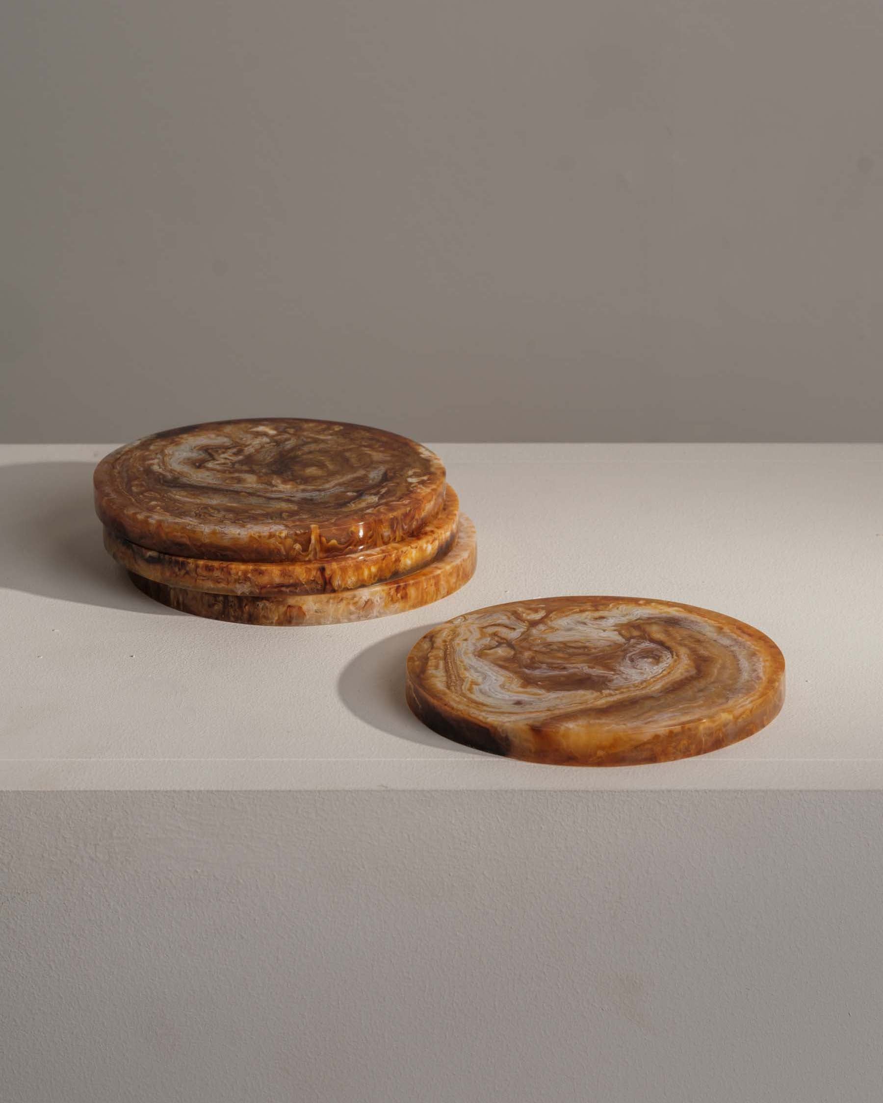 Smooth resin coasters protecting surfaces with warm tones