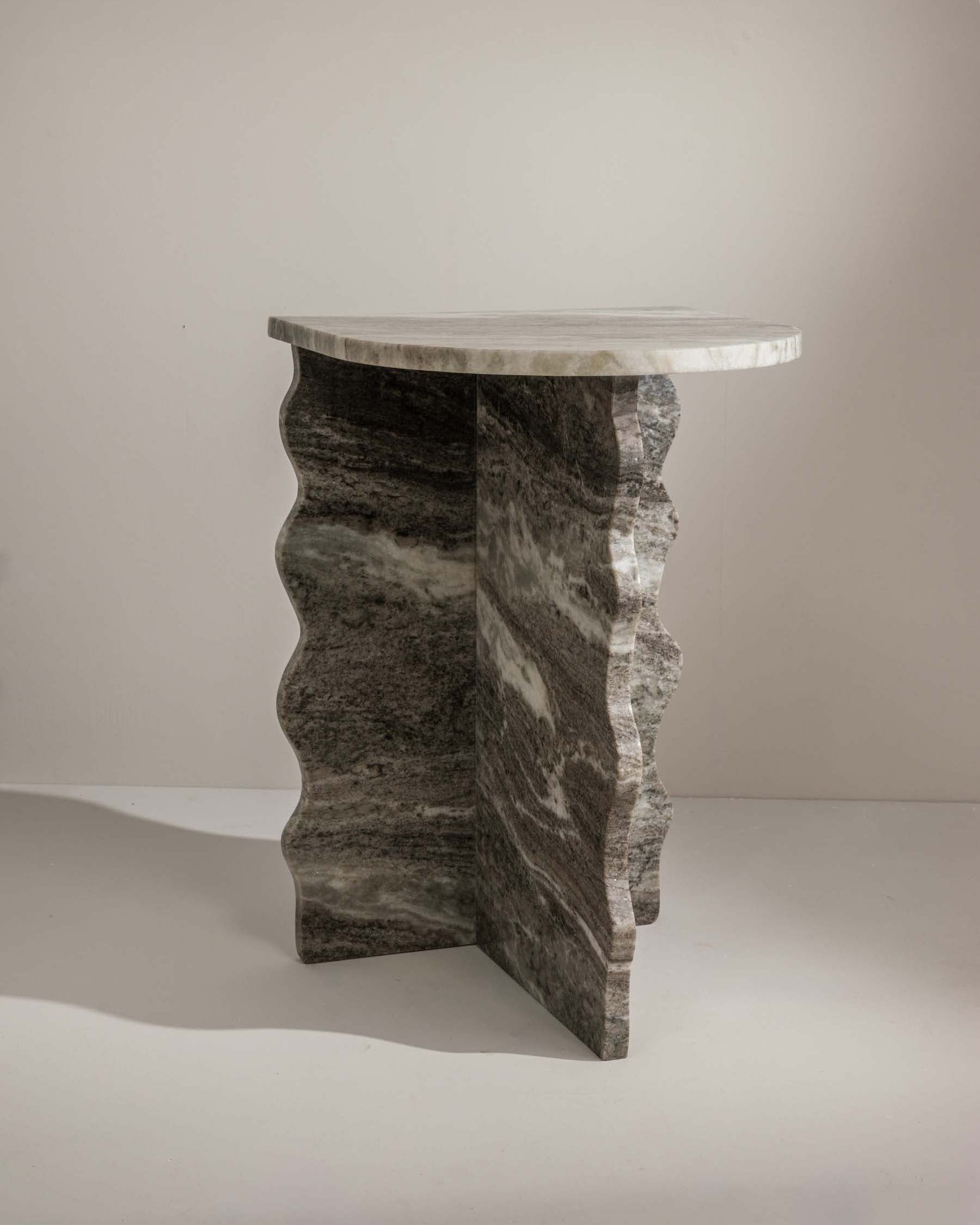 Sculptural grey marble side table with elegant silhouette