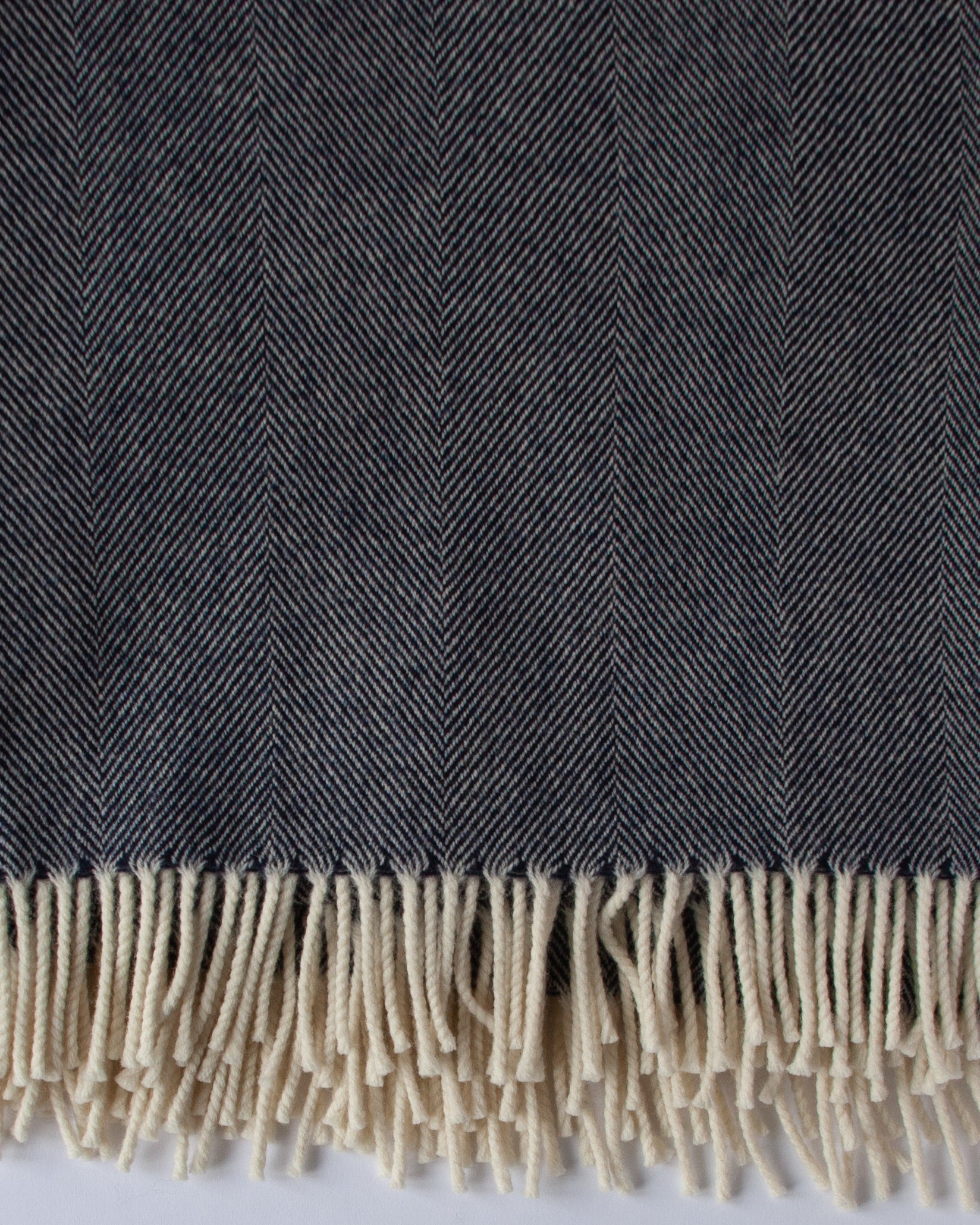 Close‑up of navy herringbone Merino weave and soft texture - Anboise